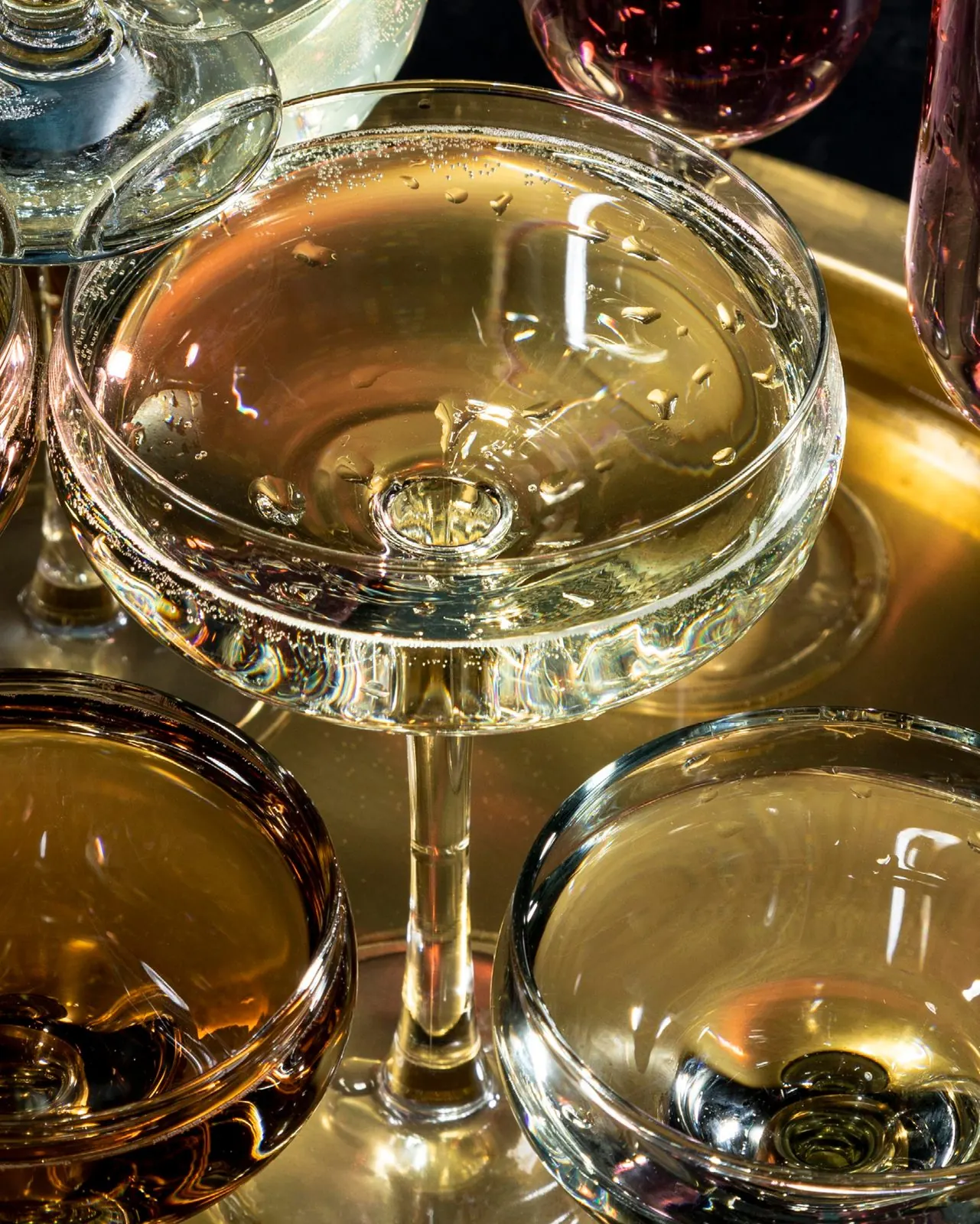 Coupes of sparkling wine on a gold tray